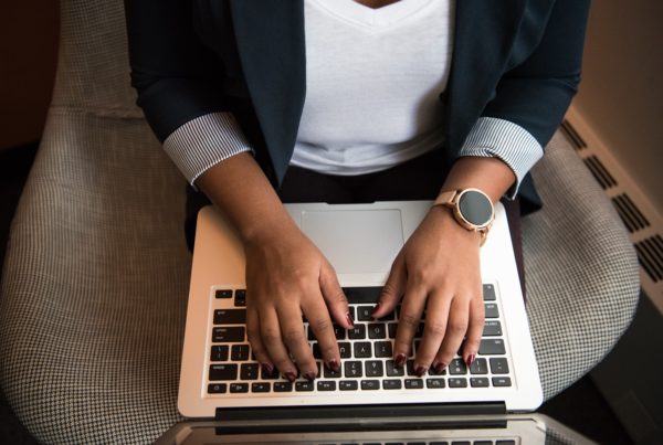Professional woman, typing on a computer.